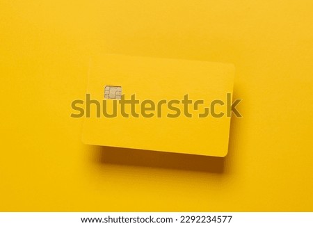 Mockup of yellow blank bank card with chip on yellow background. Template for design