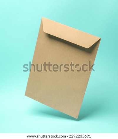 Craft postal envelope levitating on a blue background