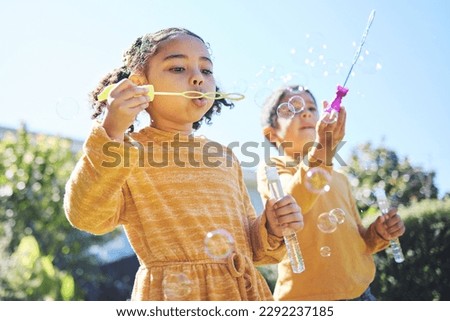 Playing, garden and children blowing bubbles for bonding, weekend activity and fun together. Recreation, outdoors and siblings with a bubble toy for leisure, childhood and enjoyment in summer