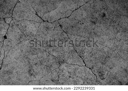 Old cement floor with crack in vintage style. Dark concrete backgrounds for wallpaper or graphic design. In the concept of structures, substandard construction is considered dangerous and unsafe. Royalty-Free Stock Photo #2292239331