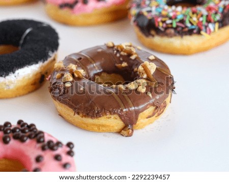 Donuts with chocolate and caramel topping on a white background. 
