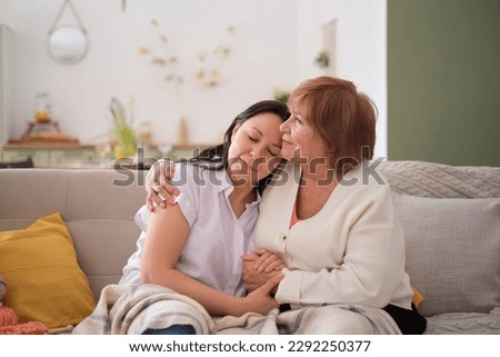 tender image of an elderly mother and her adult daughter emphasizes the emotional aspects of aging in place, discussing how families can work together to ensure comfort and safety of their loved one Royalty-Free Stock Photo #2292250377