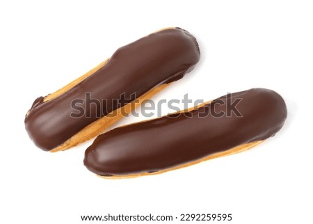 Delicious eclairs covered with chocolate isolated on white, top view Royalty-Free Stock Photo #2292259595