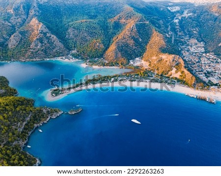 Aerial drone shot capturing the beauty of Kumburnu Beach in Ölüdeniz, Fethiye, Muğla. Showcasing the turquoise waters, coastline, and serene atmosphere of this popular summer destination. Royalty-Free Stock Photo #2292263263