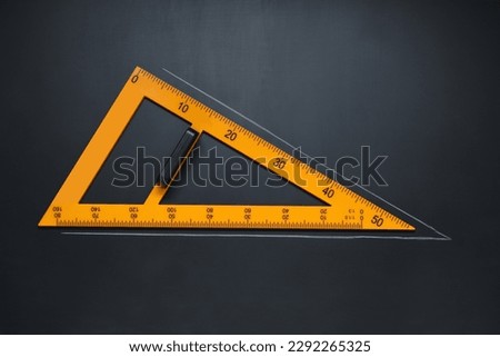 Triangle ruler with drawn acute angle on blackboard, top view Royalty-Free Stock Photo #2292265325