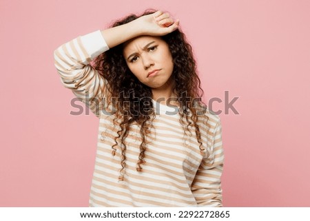 Young sad sick ill tired exhausted woman of African American ethnicity she wear light casual clothes put hand on forehead suffer from headache isolated on plain pastel pink background studio portrait