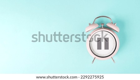 Alarm clock with pause sign, take a break, menopause concept, hormone replacement therapy Royalty-Free Stock Photo #2292275925