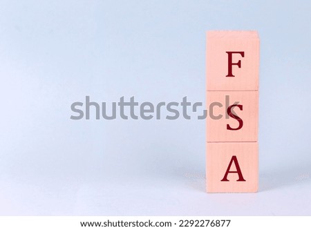 FSA on a wooden cubes on a blue background