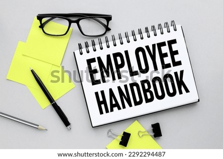 employee handbook text on notepad page near bright stickers. Royalty-Free Stock Photo #2292294487