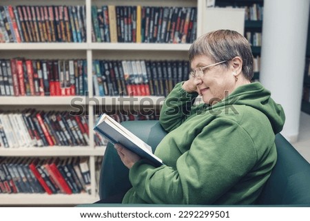 Grandmother with glasses in the city library.