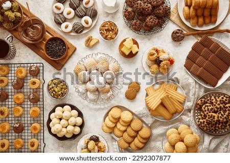 Arabic Cuisine; Eid sweets(kahk, maamoul or mamoul ,biscuits, petit four) Cookies for celebration of El-Fitr Islamic Feast Ramadan sweets. Delicious traditional biscuits and maamoul or mamoul top view Royalty-Free Stock Photo #2292307877