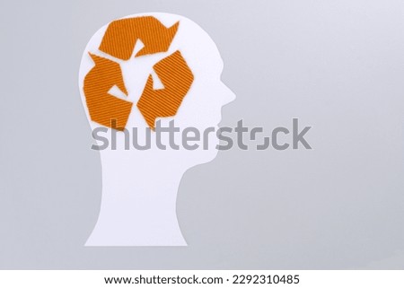 Paper cut out head with a sign of recycling clothing. Ecological and sustainable fashion. isolated. flat lay