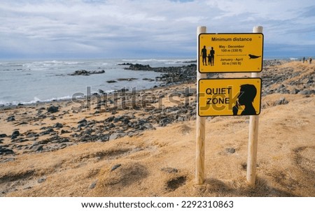 Yellow Quiet Zone and Distance warning sign on Ytri Tunga Beach in Snæfellsnes Peninsula, Iceland.
