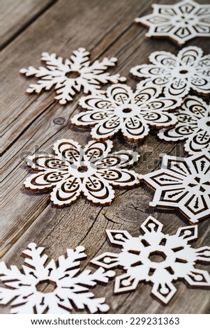 white wooden snowflakes on wooden background