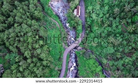 Aerial image of a mountain road flanked by rivers and cliffs