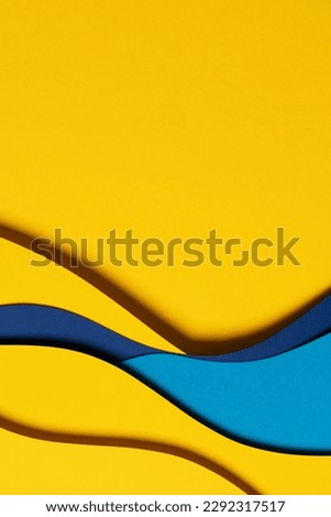 Abstract colored paper texture background. Minimal paper cut composition with layers of geometric shapes and lines in light blue and yellow colors