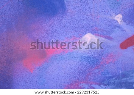 Messy paint strokes and smudges on an old painted wall background. Abstract wall surface with part of graffiti. Colorful drips, flows, streaks of paint and paint sprays Royalty-Free Stock Photo #2292317525