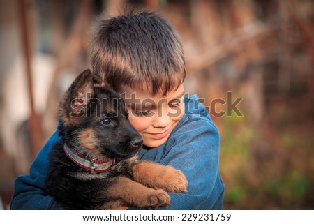 Boy with german shepherd dog puppy. Royalty-Free Stock Photo #229231759