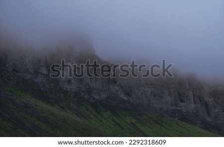 Harsh cliffs with peaks in the fog, moody landscape