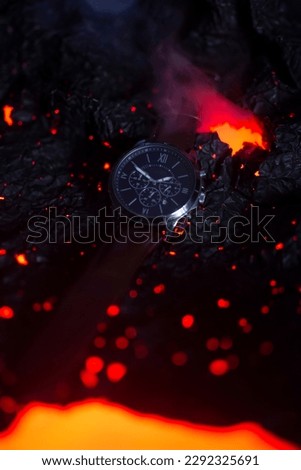 Beautiful man watch placed on a lava background, unbrekable and endurance concepts. Product picture
