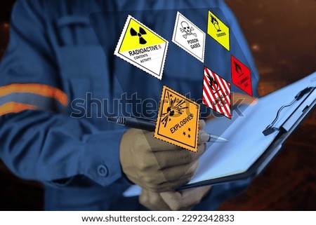 Security officers hold clipboards and inspect the storage of dangerous goods in the warehouse for operator safety such as explosions, radioactive, toxic gases, etc. Royalty-Free Stock Photo #2292342833