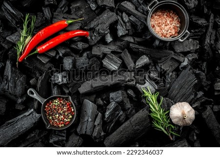 BBQ grill coal texture with fresh herbs, spices and kitchen utensils, cooking background, place for text, top view,