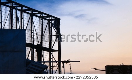 Silhouette of metal frame with beautiful orange and blue sunset sky background
