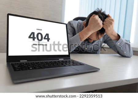 Man working on laptop, 404 error, the message on the screen page not found problem with loading the site .a sad man grabs his head with his hands. An enraged programmer at work. Royalty-Free Stock Photo #2292359513