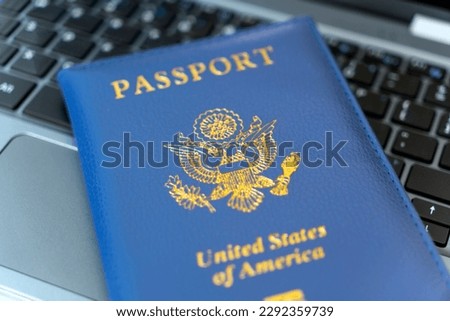 Passport of USA on Notebook's keyboard, close up. Identification of the user on the Internet. Prohibition of access to the Internet without passport data. issuing a passport via Internet Royalty-Free Stock Photo #2292359739