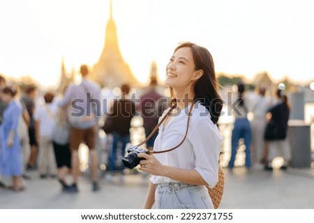 Portrait beautiful asian woman smiling while travel at Wat Arun sunset view point, Bangkok, Thailand.