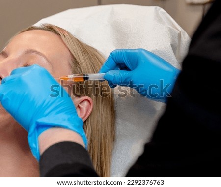 PRP or PRF eye treatment on unreognizable face and blurred foweregound  Royalty-Free Stock Photo #2292376763
