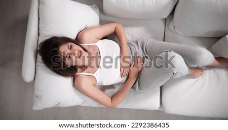 Sick Woman With Abdominal PMS Hormone Period Pain Royalty-Free Stock Photo #2292386435