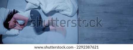 Woman With RLS - Restless Legs Syndrome. Sleeping In Bed Royalty-Free Stock Photo #2292387621