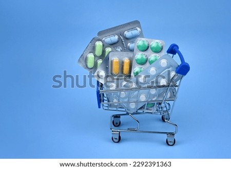 The concept of medicine. A set of pills. a set of medicines. Various capsules. on a blue background, the concept of pills, buying medicines and shopping. Royalty-Free Stock Photo #2292391363