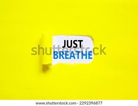 Just breathe and psychological symbol. Concept words Just breathe on beautiful white paper. Beautiful yellow table yellow background. Business psychological and Just breathe concept. Copy space