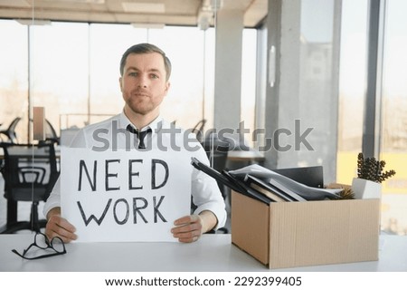 Sad Fired. Let Go Office Worker Packs His Belongings into Cardboard Box and Leaves Office. Workforce Reduction, Downsizing, Reorganization, Restructuring, Outsourcing. Mass Unemployment Market Crisis. Royalty-Free Stock Photo #2292399405