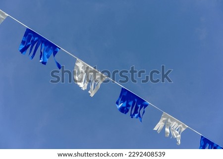 A row of alternating white and blue flags in the colors of the Israeli flag. Royalty-Free Stock Photo #2292408539