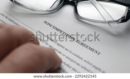 Finger tapping on non competition agreement Royalty-Free Stock Photo #2292422145