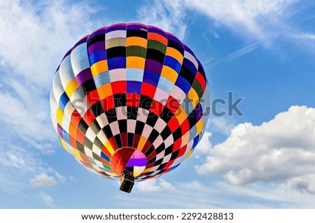 Colorful hot air balloon flying over blue sky with white clouds Royalty-Free Stock Photo #2292428813