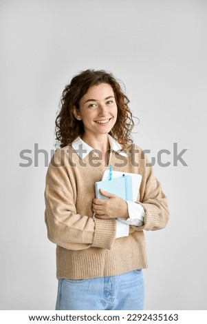 Young happy pretty cute girl student holding digital tablet, using tab computer standing isolated at white background advertising online education course on smart technology, vertical.