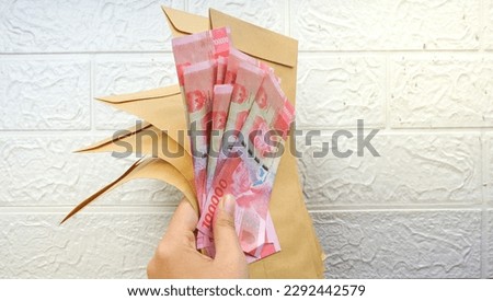 Rupiah banknotes money in brown envelope. Indonesian bills in envelope.
