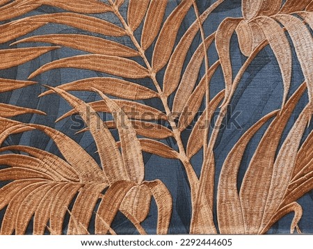 LEAF REGISTRATION IN BROWN TONE ON BLUE FABRIC BACKGROUND.