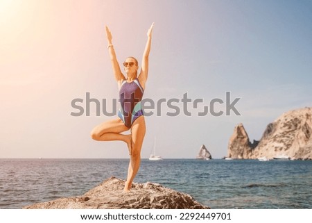 Woman sea yoga. Happy woman meditating in yoga pose on the beach, ocean and rock mountains. Motivation and inspirational fit and exercising. Healthy lifestyle outdoors in nature, fitness concept.