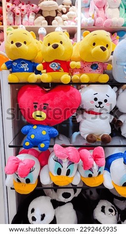 Various types of dolls neatly arranged in a shop window are ready to be made as gifts for loved ones