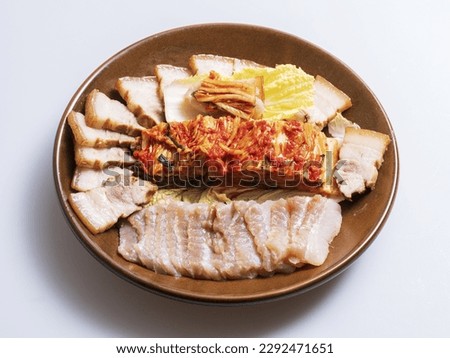 Close-up of Hongeo Samhap Suyuk(Boiled Pork Slices) with raw skates flesh and ripened kimchi on a dish, South Korea
