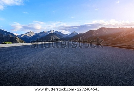 Straight asphalt road and mountain natural background at sunset