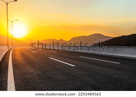 Asphalt road and mountain natural background at sunset