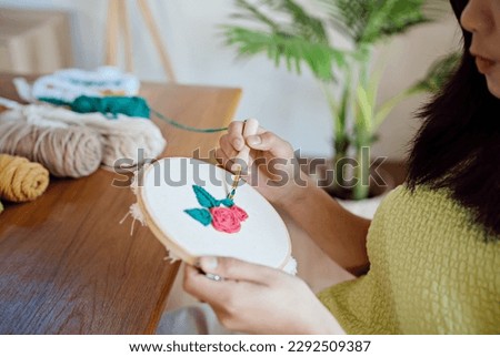 Punch needle. Asian Woman making handmade Hobby knitting in studio workshop. designer workplace Handmade craft project DIY embroidery concept Royalty-Free Stock Photo #2292509387