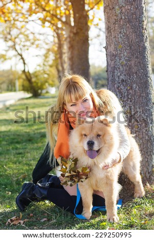 Attractive girl with her dog wearing warm clothes