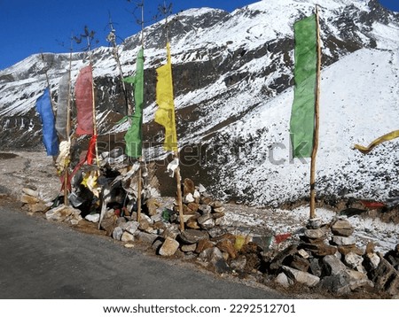 Colorful prayer flags flutter on the backdrop of mountains at Yumesamdong situated at 16500 ft altitude in North Sikkim. This is the most popular tourist spot of Sikkim, India. 

 Royalty-Free Stock Photo #2292512701